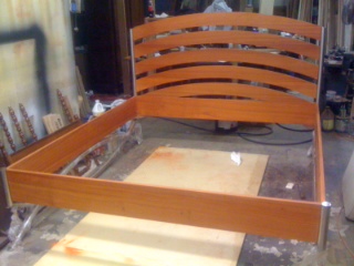 Padauk Bed 
Solid Padauk wood headboard and rails on custom stainless steel frame.
